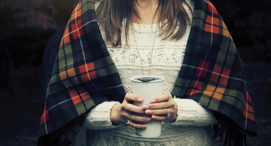 woman sitting on flight best airplane travel blankets
