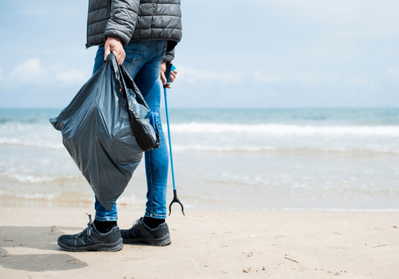 person with trash bag and a grabber grabbers for seniors