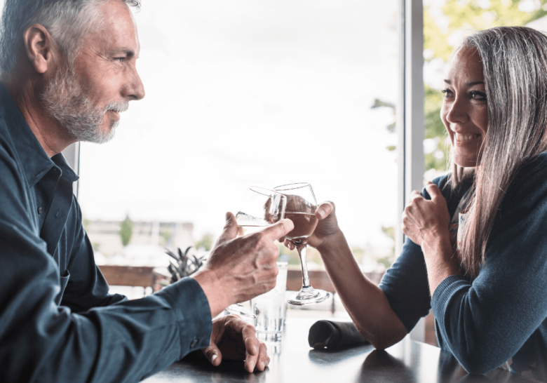 mature couple having a drink together red flags when dating in your 50s