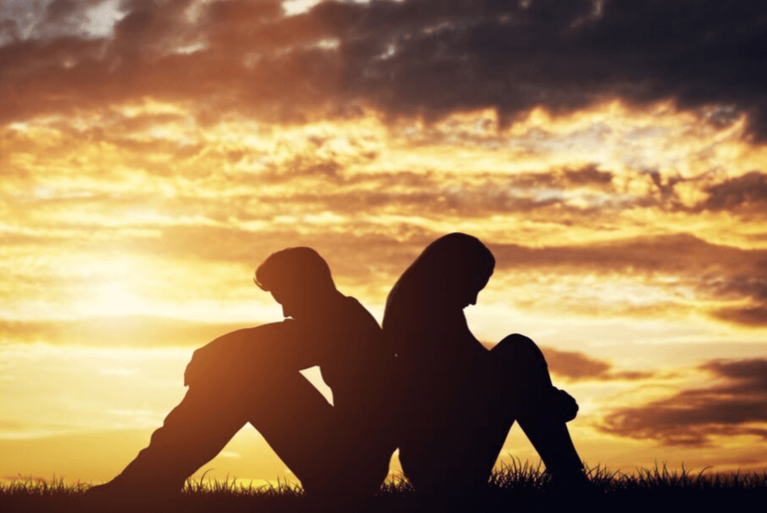 couple sitting at sunset, unhealthy relationship
