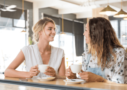 woman sitting at coffee bar talking how to be a good listener