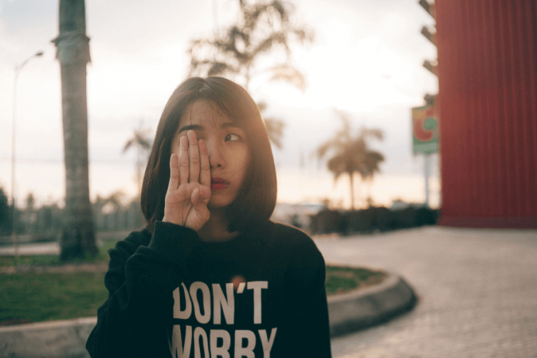 woman covering one eye emotionally unavailabe women