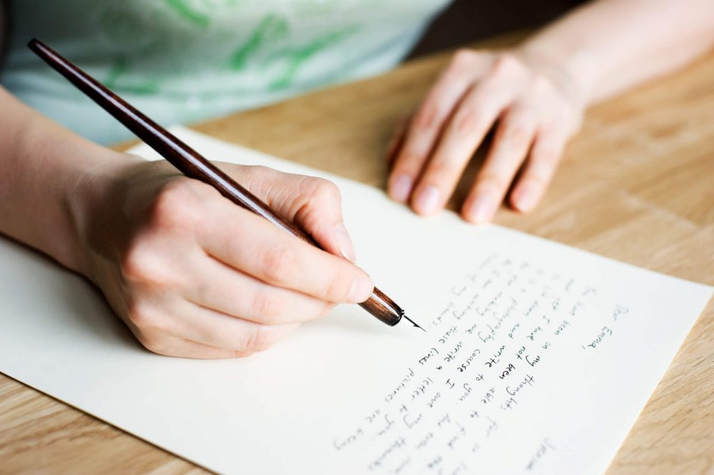 man writing not with pen love letter for her