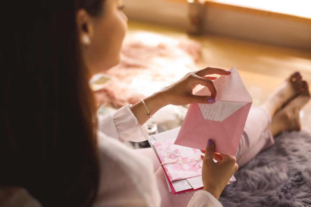 woman opening envelope love letter for her