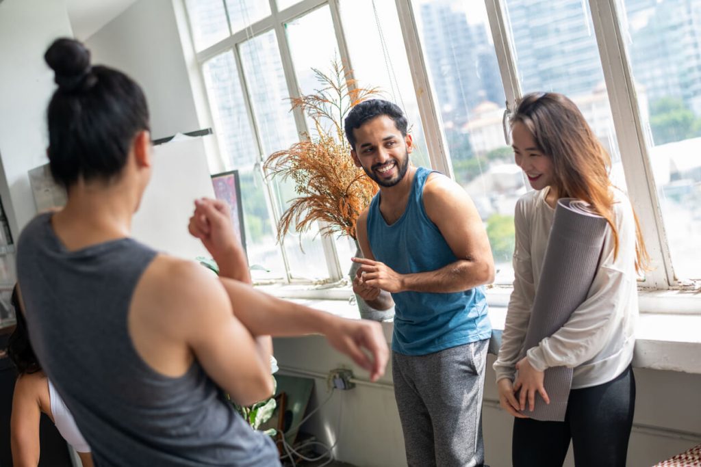 man and woman yoga class how to make friends in a new city