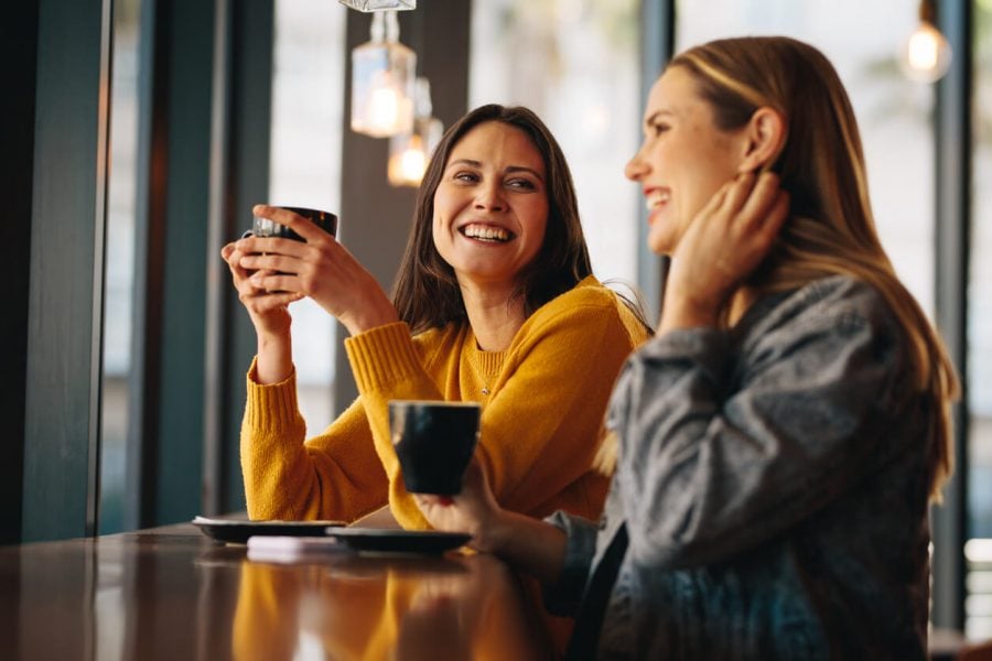 two girls laughing in the coffee shop platonic soulmates