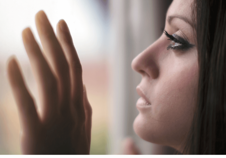 woman looking out window how to break a soul tie