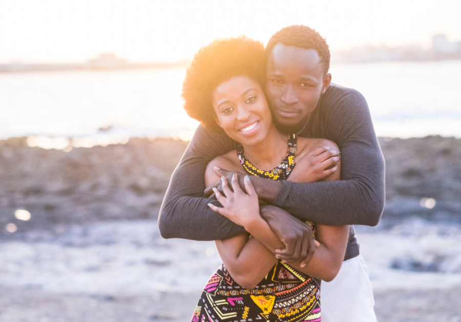 sweet couple hugging by the beach dating vs. relationship