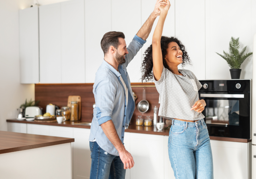 young couple happily dancing in the kitchen romantic thing to do for your wife