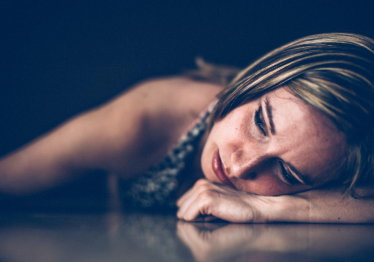 woman leaning on the table when a narcissist sees you cry