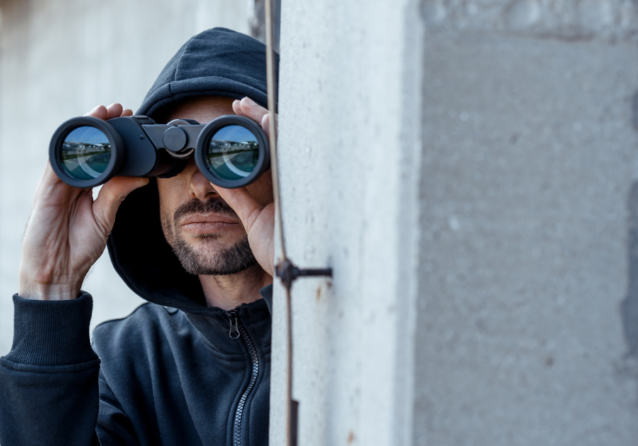 man looking at something through his binoculars when a narcissist sees you have moved on