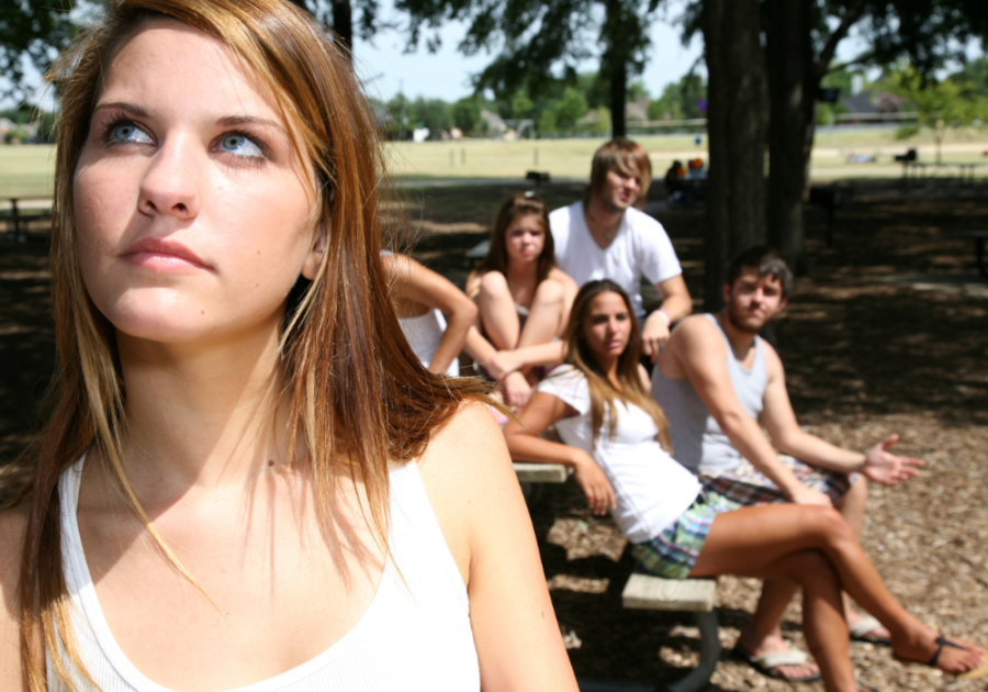 group of friends looking at the girl signs he wants you to leave him alone