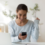 woman smiling while reading phone I miss you texts for her