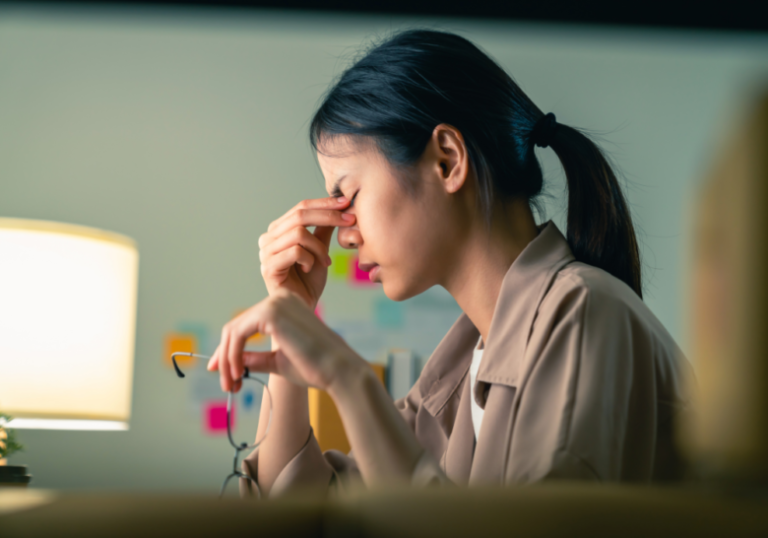 woman massaging the bridge of her nose triggers for empath