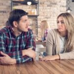 man and woman talking at table how to know it's time to break up