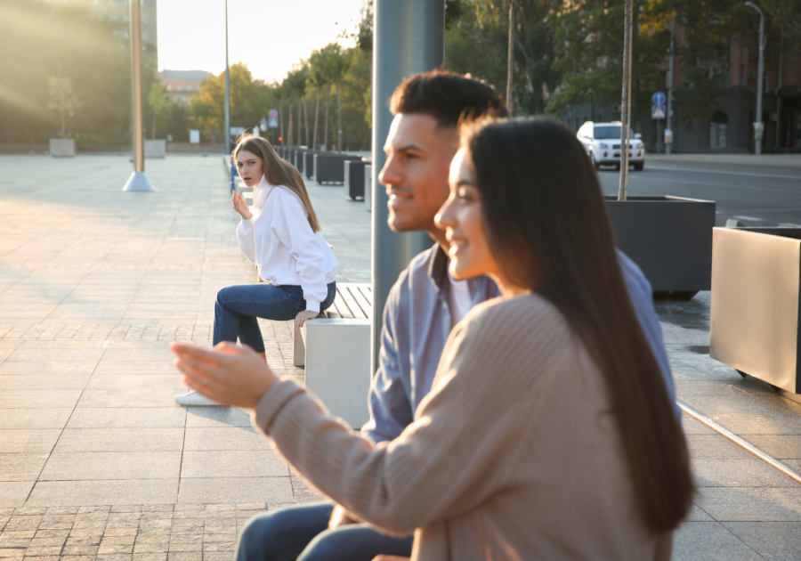 couple sitting outside being watch by another woman what happens when a Narcissist Finds a New Supply