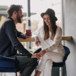 Couple having coffee holding hands Signs A Woman Is Sexually Attracted To You