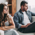 couple sitting on sofa sad Why Am I So Mean To My Boyfriend