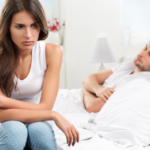 man in bed woman sitting on side of bed When To Walk Away From A Sexless Marriage