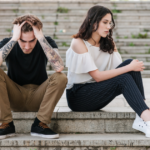 couple sitting on steps emotions Signs He's Pretending To Love You