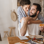 woman hugging man at dining table hero instinct