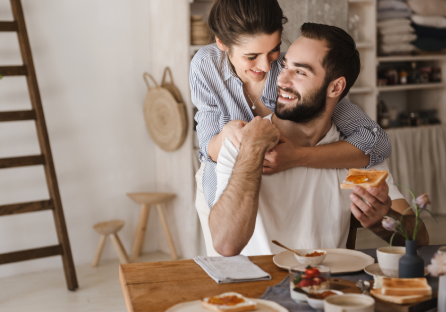 woman hugging man at dining table hero instinct