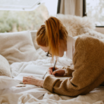 woman writing on paper birthday letters for husband