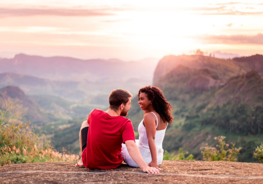 couple sitting on ledge in mountains Green Flags in a Relationship