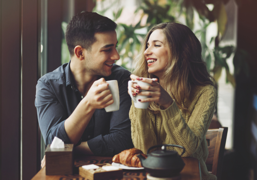 couple laughing sitting for coffee Green Flags in a Relationship