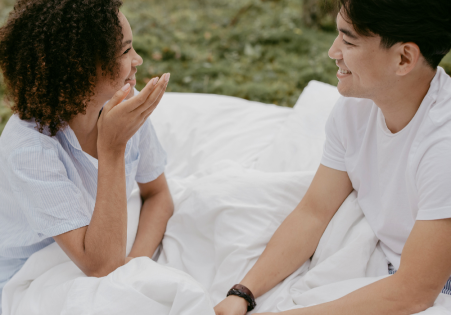 couple sitting outside talking under blankets 80/20 Rule in Relationships