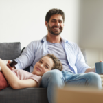 couple sitting on sofa watching tv movies to watch with your boyfriend