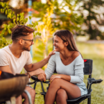 couple sitting outside talking Weird Questions to Ask a Guy