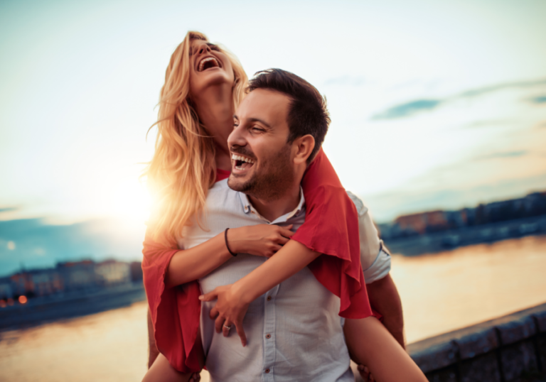couple laughing woman riding on his back best match for Aries woman
