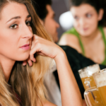 woman drinking beer alone at bar Reasons Guys Don't Like You