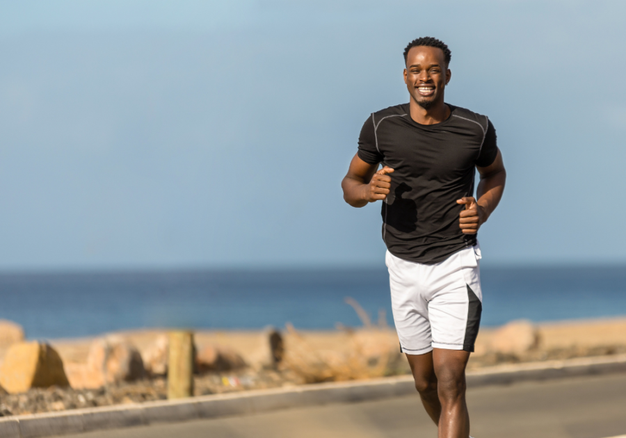 man running by ocean smiling Conventionally Attractive