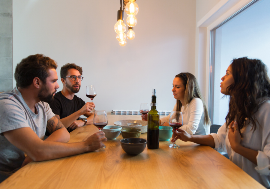4 people sitting at table drinking wine signs of a Condescending Person