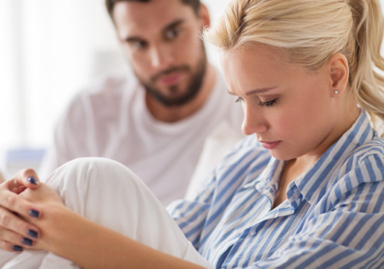 couple sitting together woman is sad Power Dynamics in Relationships