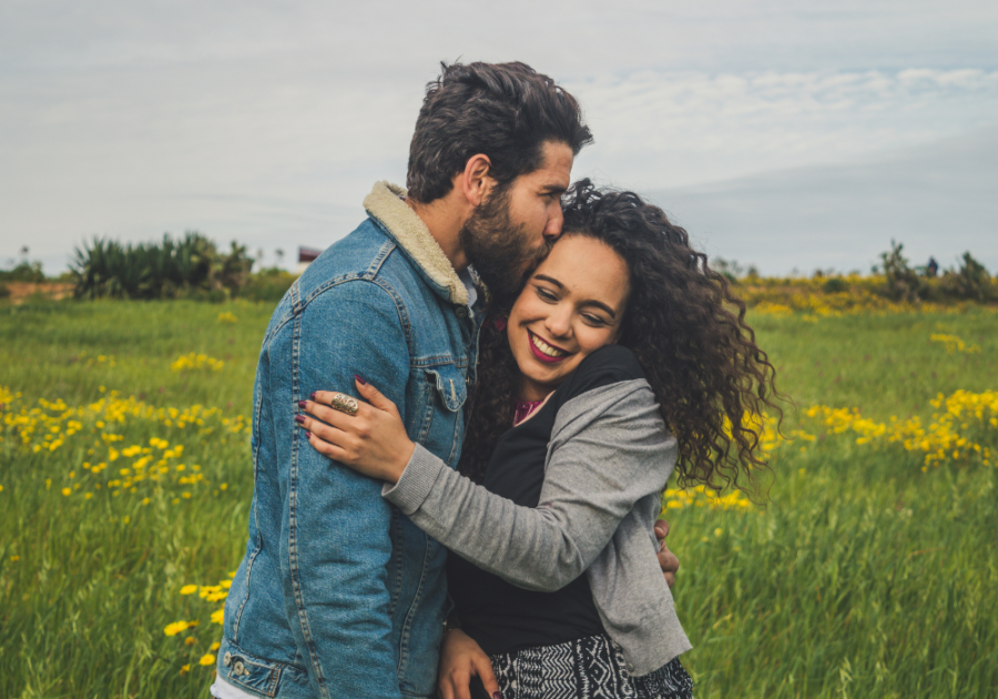 couple in meadow hugging 80/20 Rule in Relationships