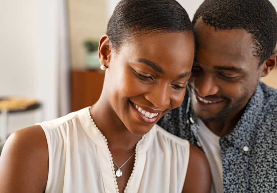 couple smiling and standing close Signs of an Aries Man in Love