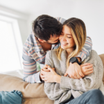 Man hugging woman from behind Respect Your Wife's Feelings