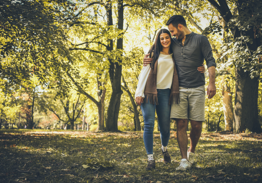 couple walking in woods arm in arm 80/20 Rule in Relationships