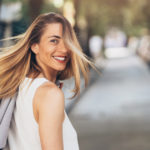 Woman walking down street smiling Facts About The Aquarius Woman