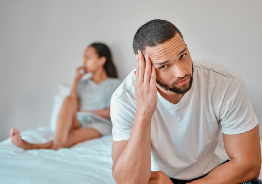 man sitting on end of bed away from woman Too Long Without Sex in a Relationship