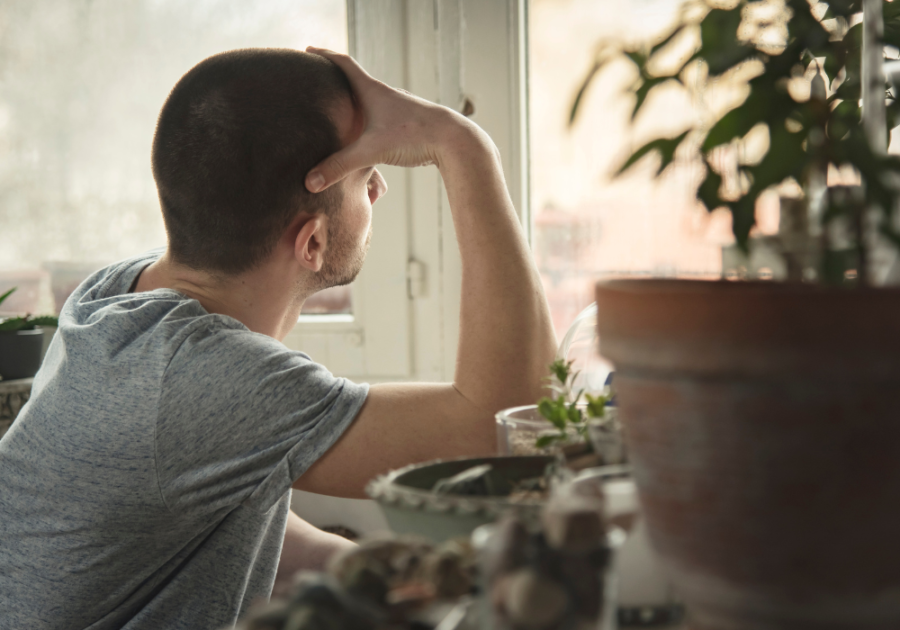 sad man looking away out window How to Get Over Someone You Love