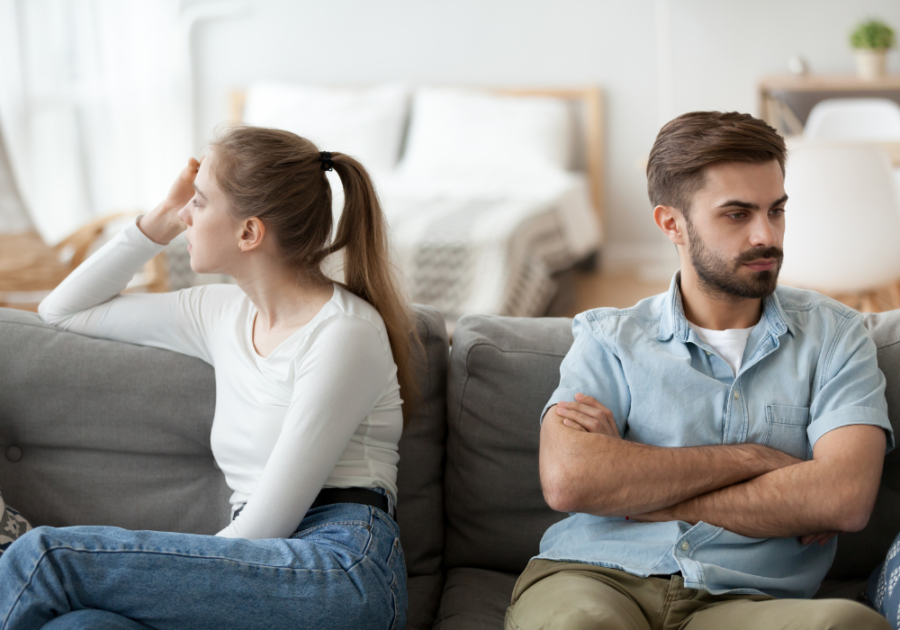 couple upset sitting on sofa Passive-Aggressive Examples in a Relationship