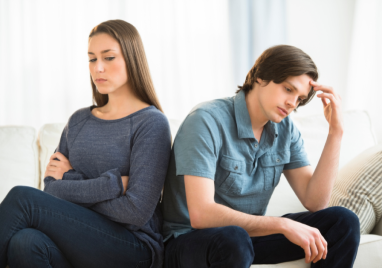 couple sitting back to back Passive-Aggressive Examples in a Relationship