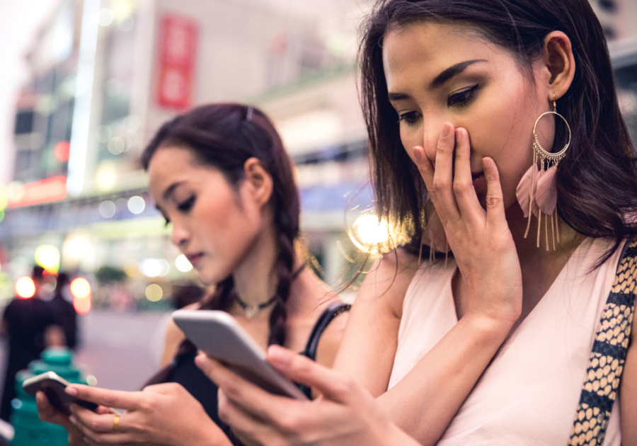 two women looking at phones did he block you because he cares