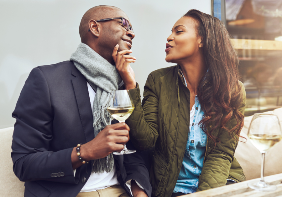 woman smiling touching man's face Do Guys Like Being Called Handsome