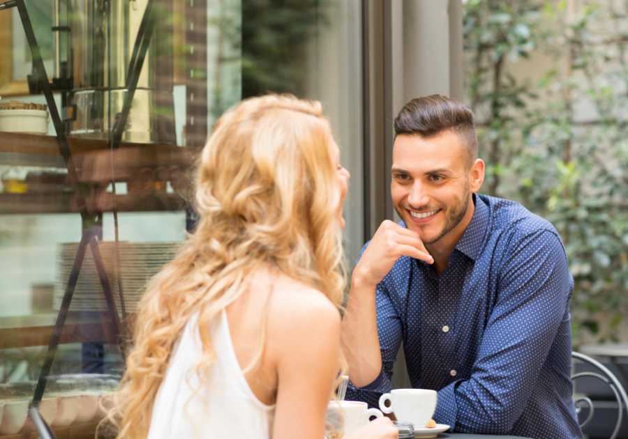 couple smiling outdoors at table 5 Stepping Stones in a Relationship