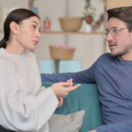 couple talking on sofa Compromise in a Relationship